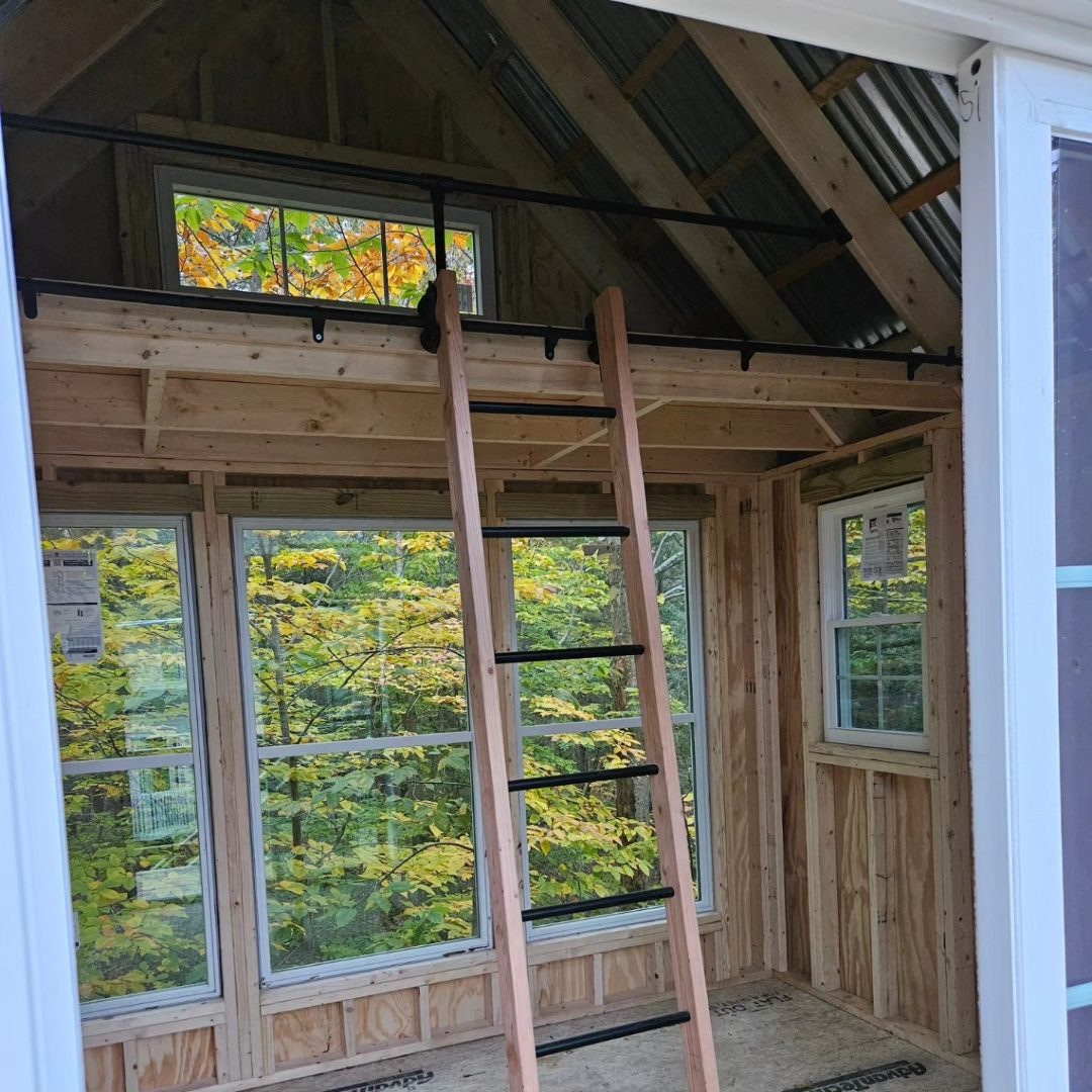 Interior rolling ladder inside a custom enclosed treehouse