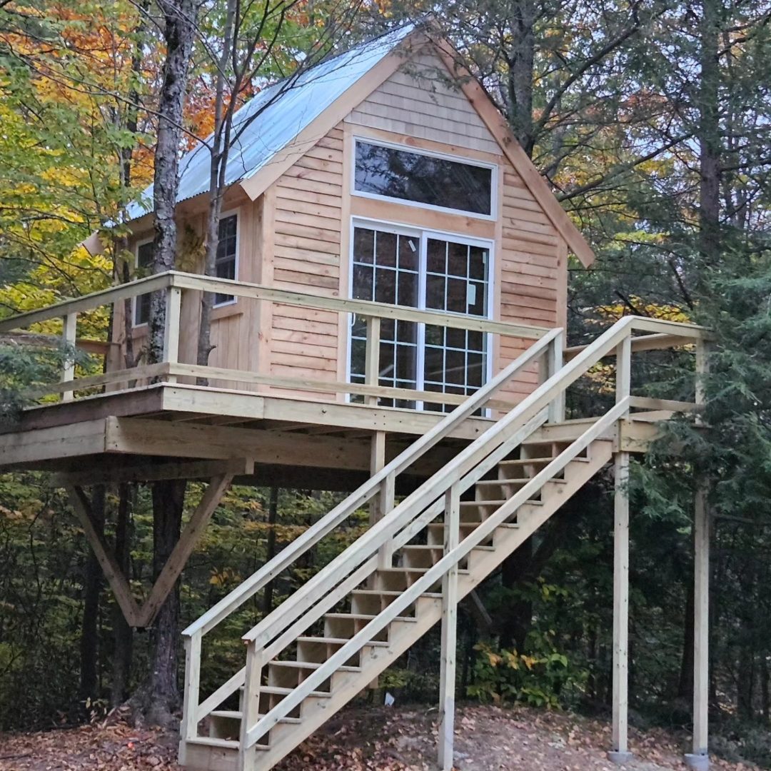 Custom treehouse with staircase and enclosed cabin