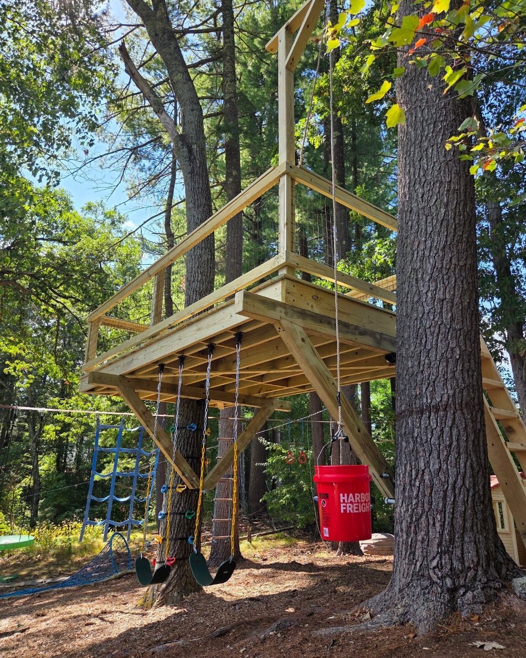 Treehouse swing area beneath a raised platform